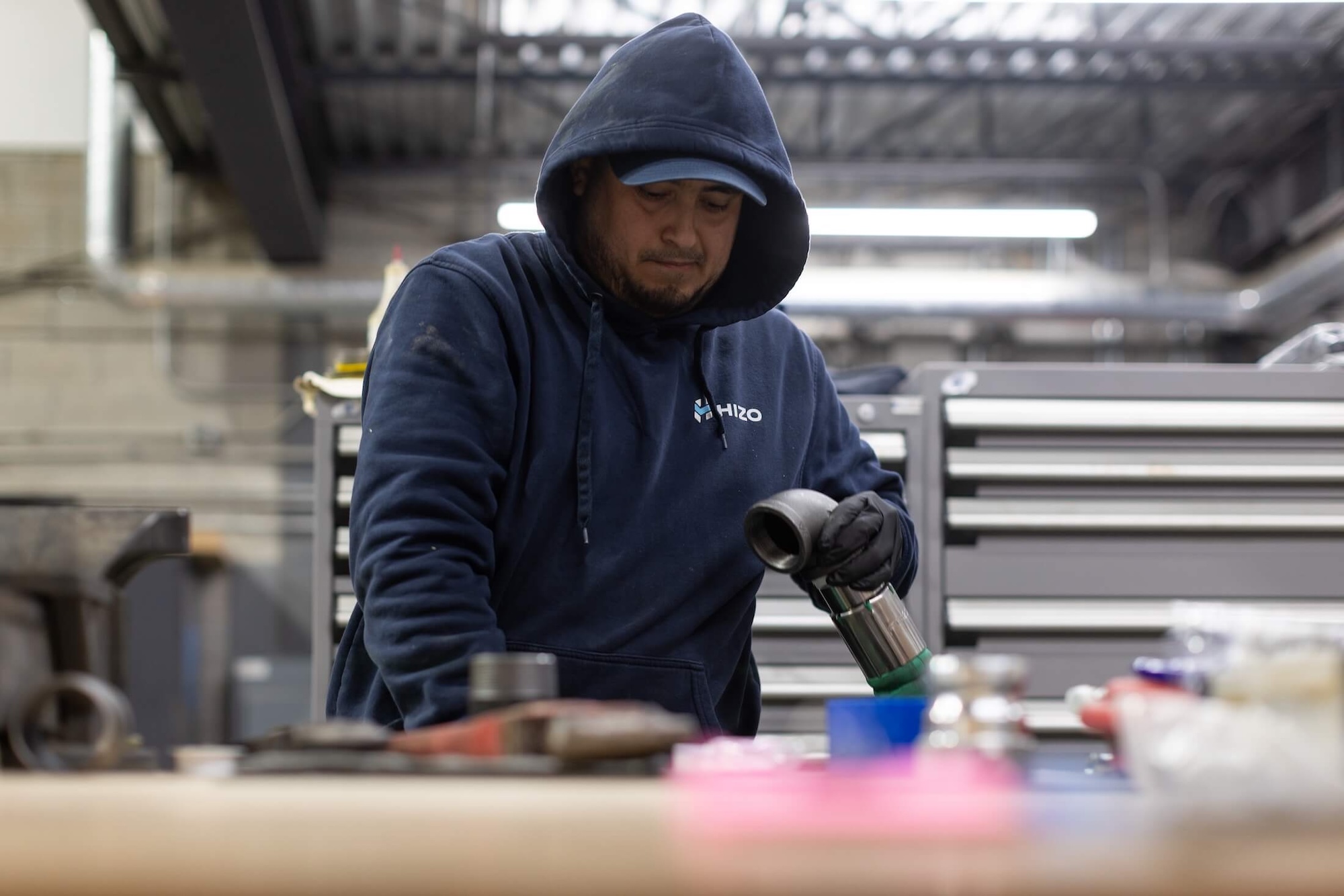 HIZO technician inspecting equipment fittings